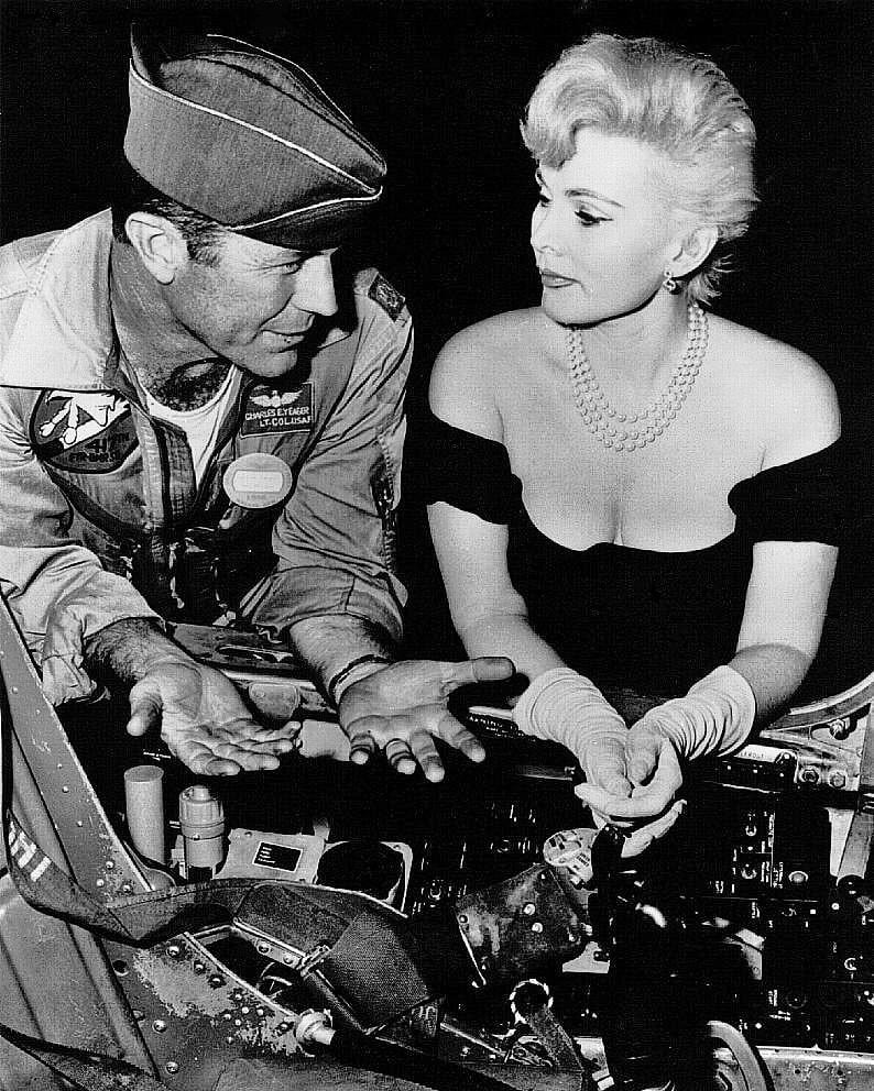 Chuck Yeager showing the inside of a cockpit to actress Zsa Zsa Gabor ...